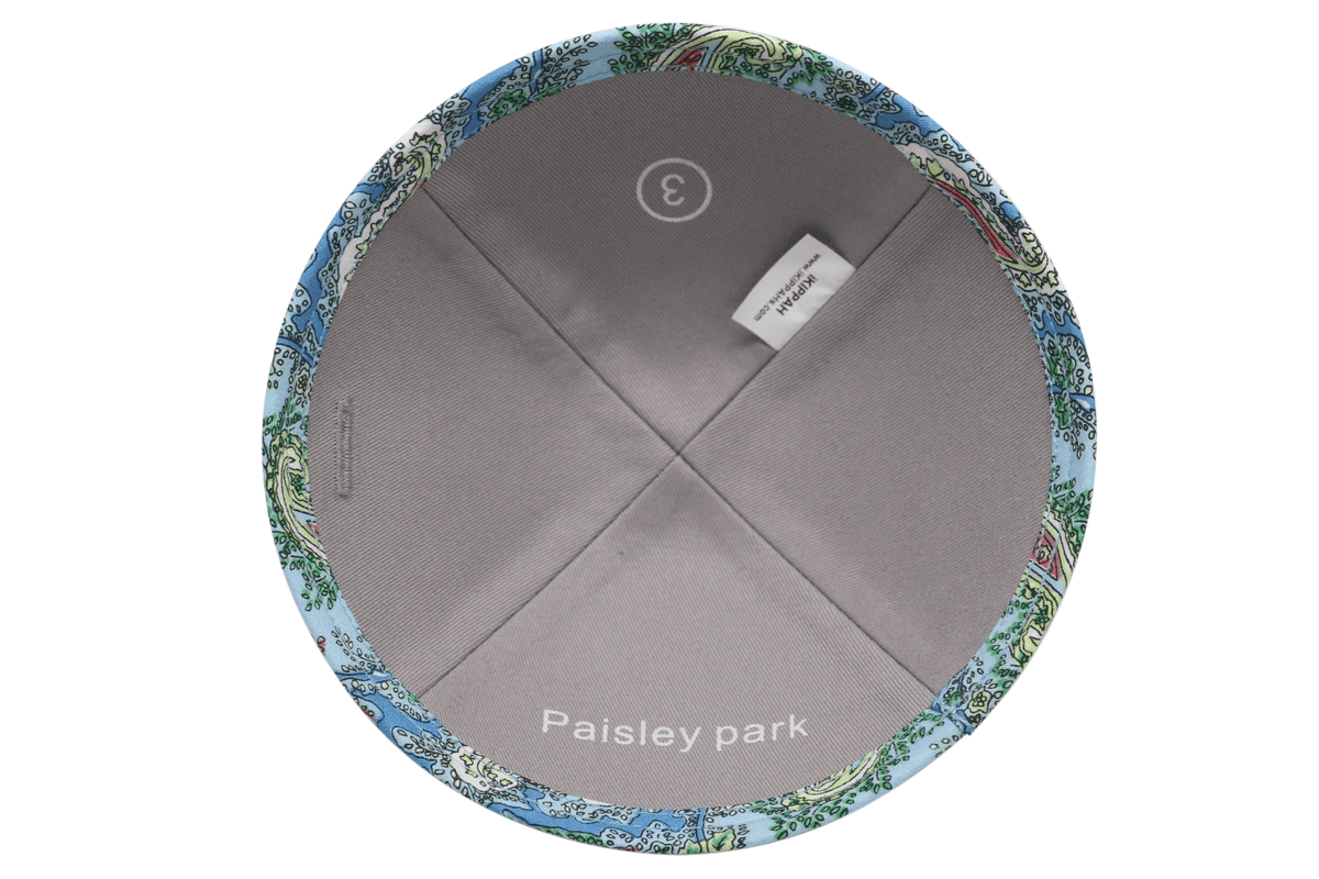 A primarily blue paisley patterned iKIPPAH brand yarmulke inside view.