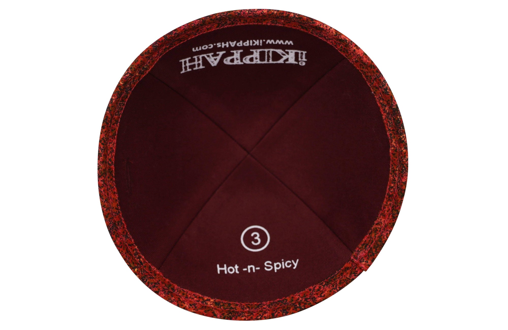 A red-ish orange iKIPPAH brand yarmulke the same color of spicy hot sauce inside view.