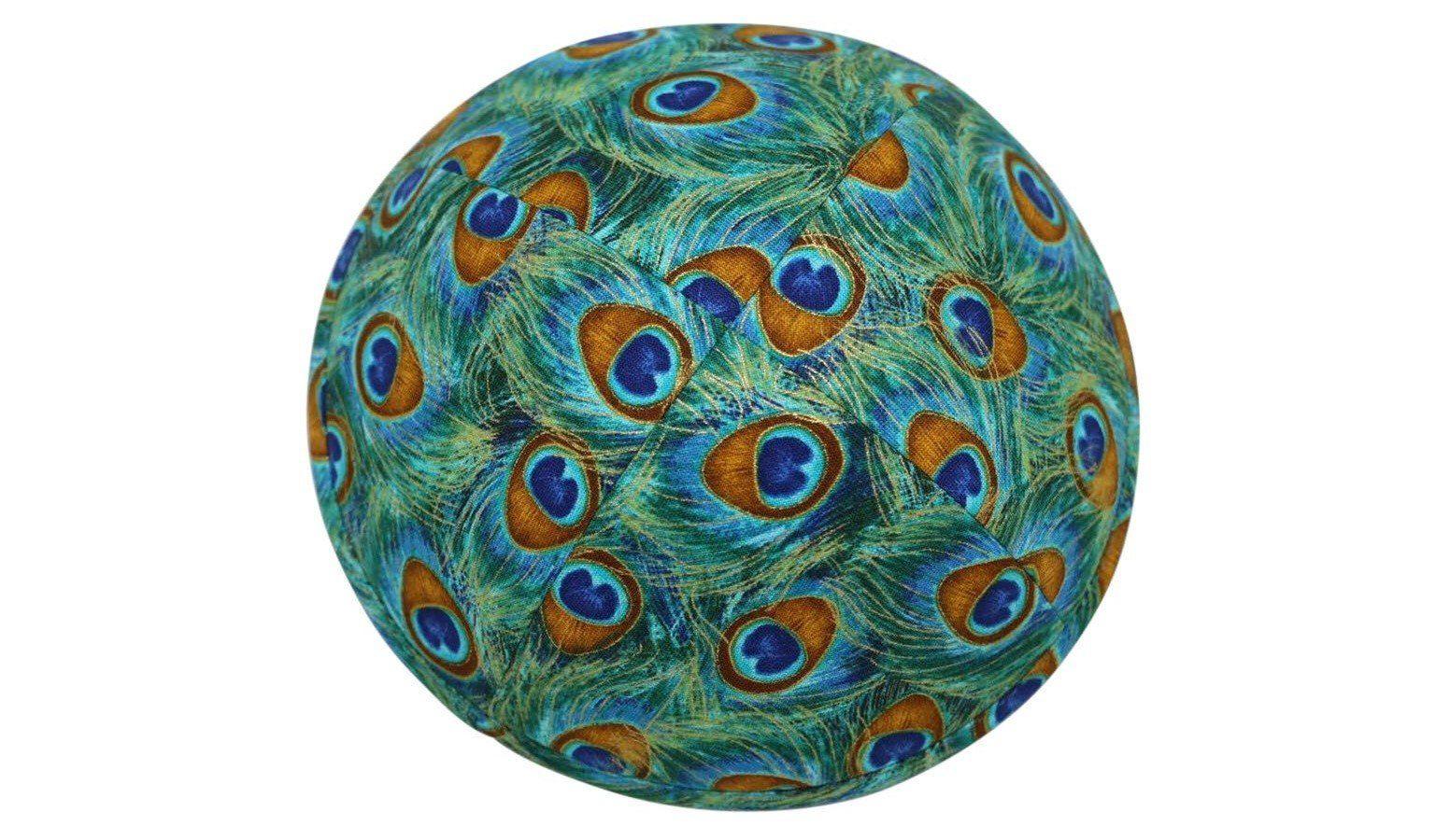 An iKIPPAH brand yarmulke that is an artist's rendition of exotic peacock feathers in shades of bright grean, blue & brown top view.