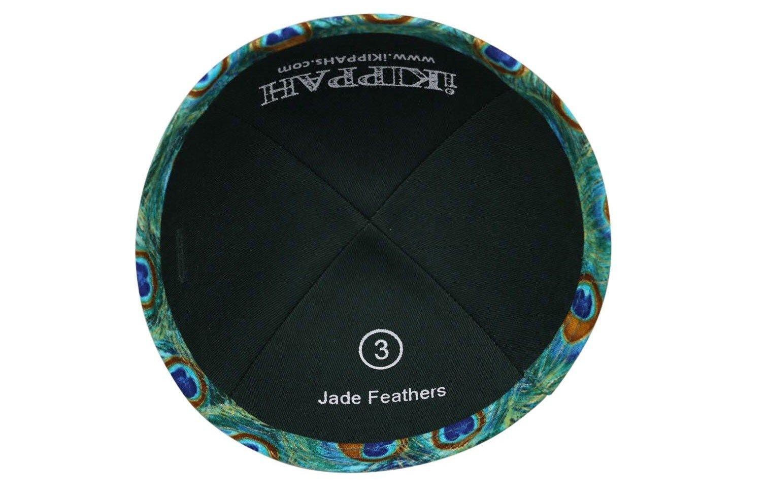 An iKIPPAH brand yarmulke that is an artist's rendition of exotic peacock feathers in shades of bright grean, blue & brown inside view.