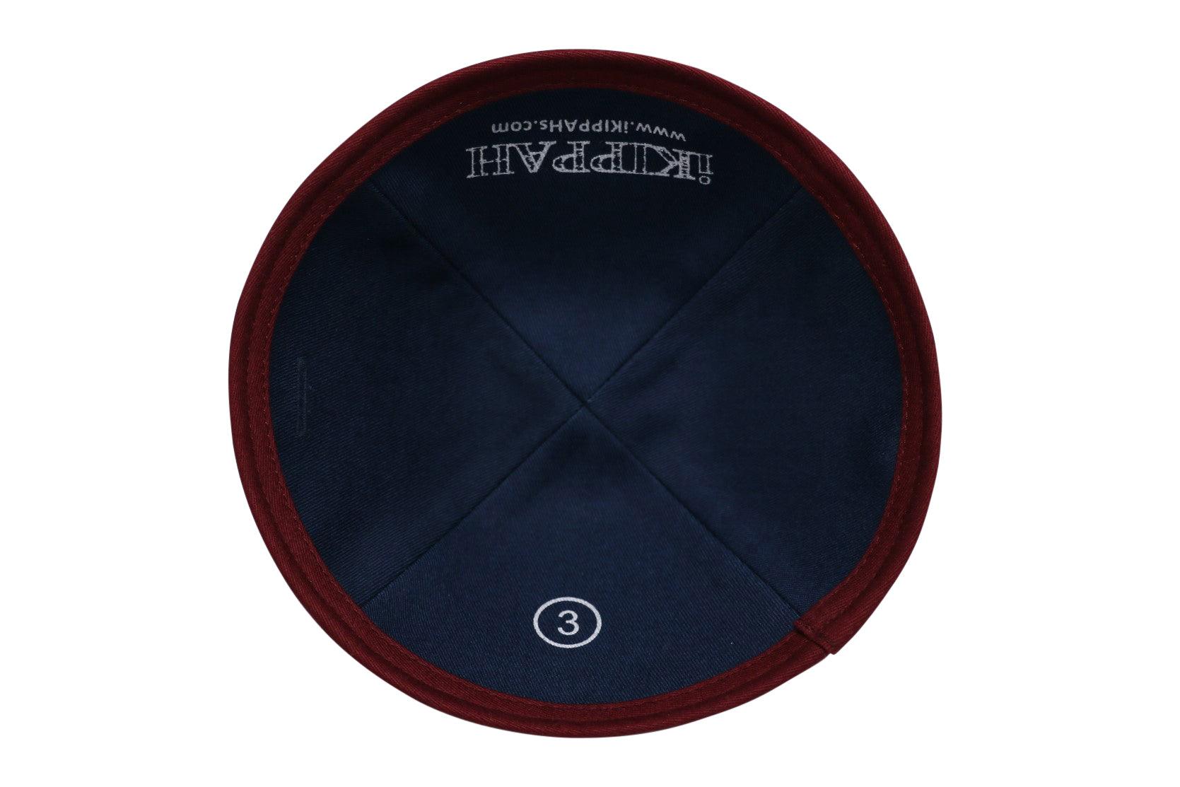 A maroon velvet iKIPPAH brand yarmulke inside view.