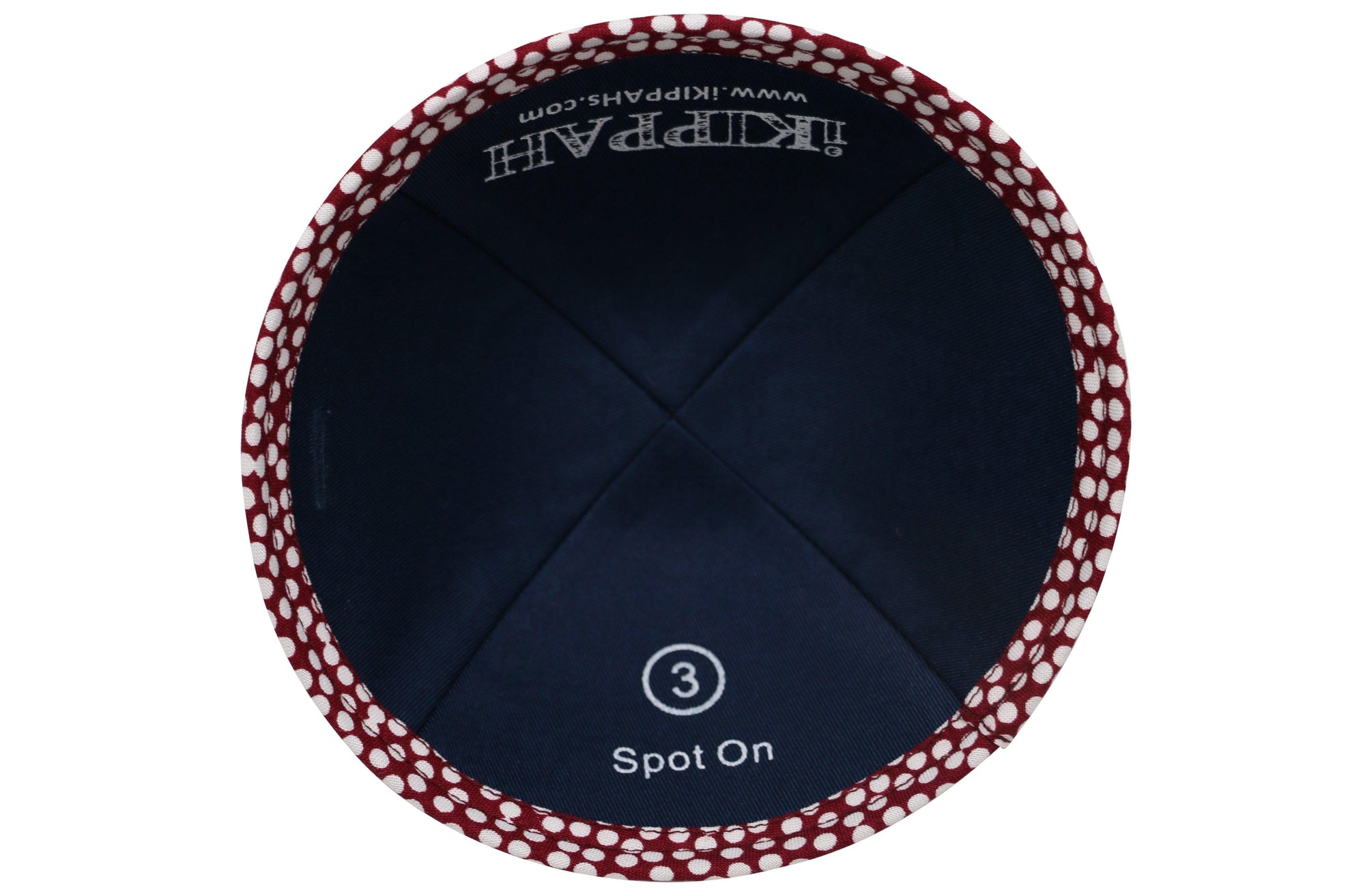 A maroon iKIPPAH brand yarmulke covered with hundreds of small white circular spots inside view.